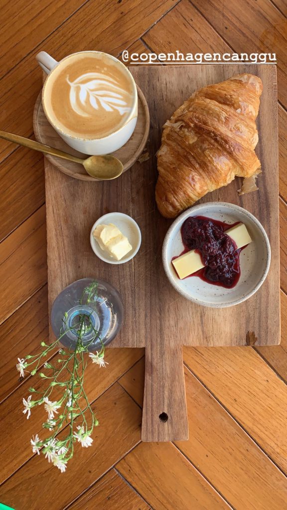 Croissant, jam, butter, and cappuccino on the yoga retreat.