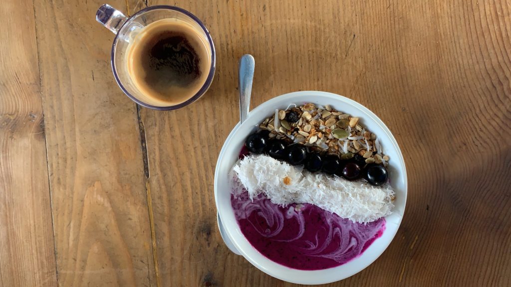 Porridge with jam and berries with black coffee on the yoga retreat.