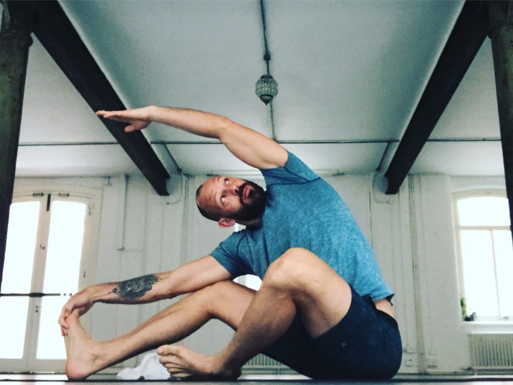 Doug Robson doing yoga in his yoga class room.